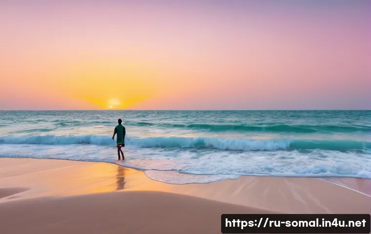소말릴란드 해안 도시 탐방 - A wide, pristine beach in Berbera, Somaliland, at sunrise. The turquoise water gently laps against t...